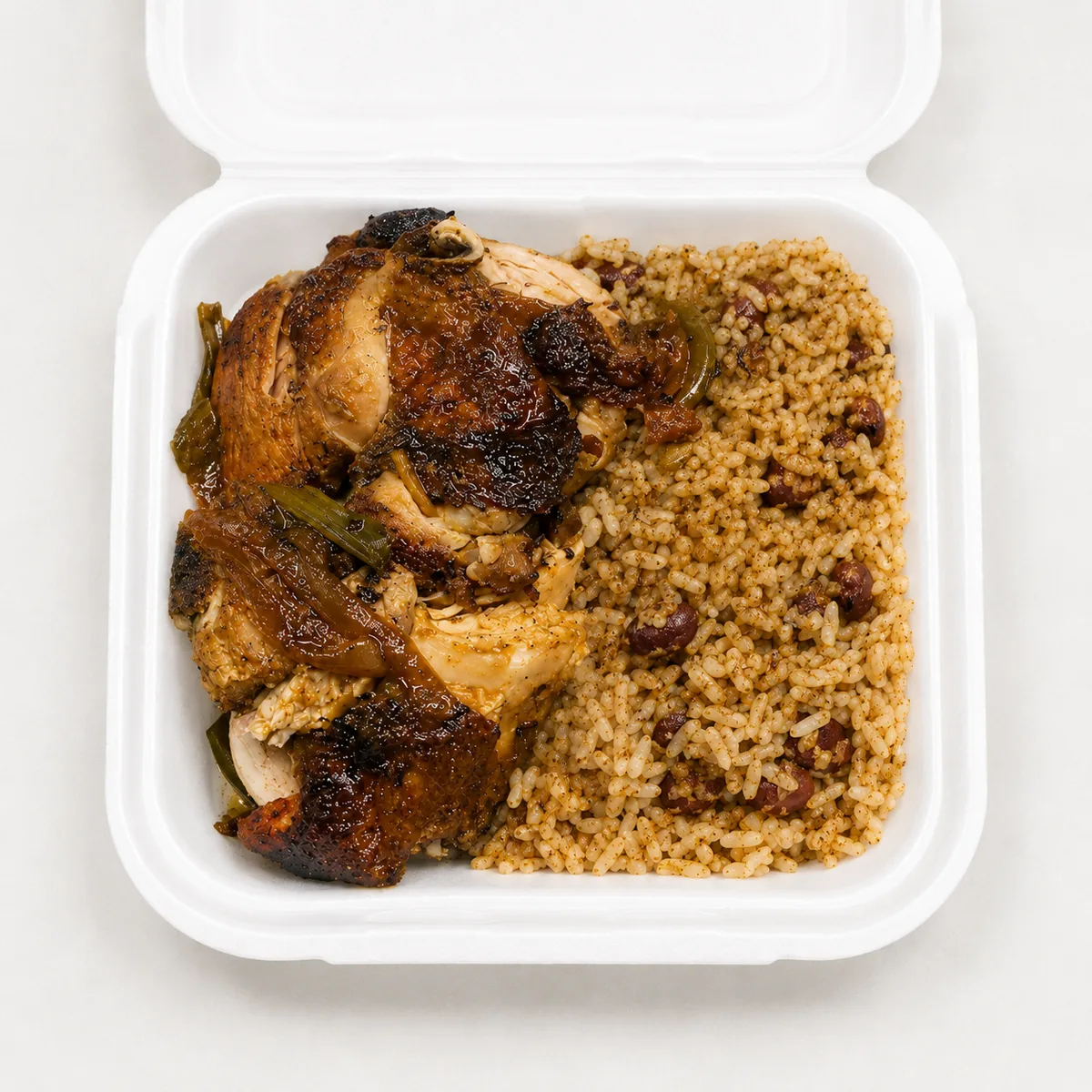 Jerk chicken meal in a white takeout container