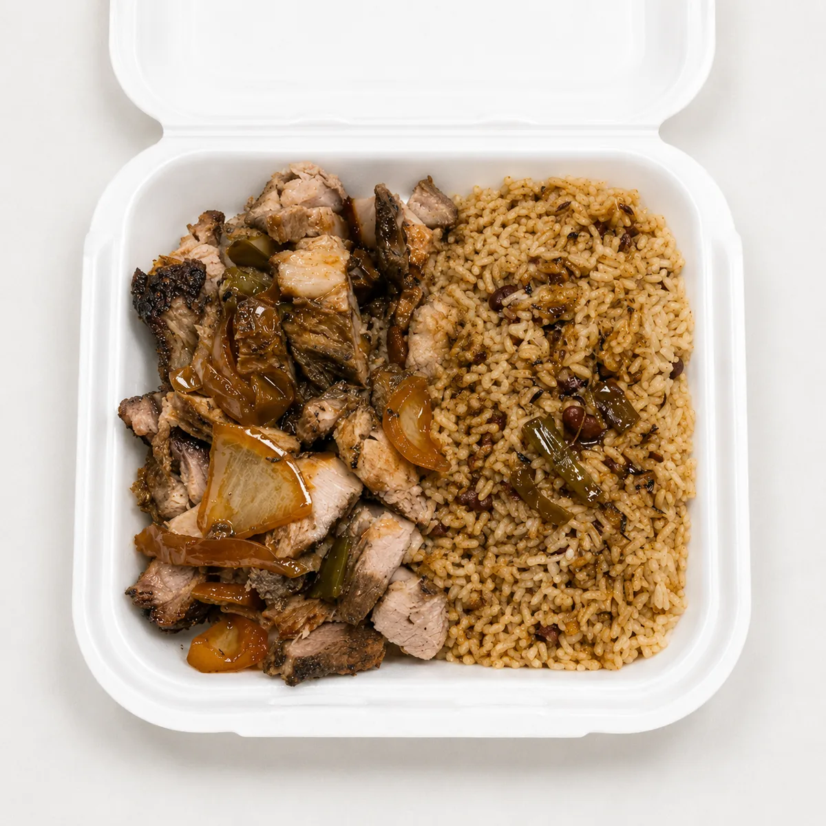 Jerk pork meal in a white takeout container